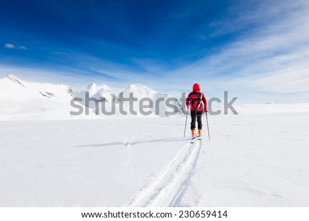 Mountaineer walking on a glacier during a high-altitude winter expedition in the european Alps. Breithorn, Monte Rosa massif, Valle d\'Aosta, Italy, Europe.