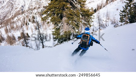 Winter sport: man skiing in powder snow. Val D'Aosta, italian Alps, Europe.