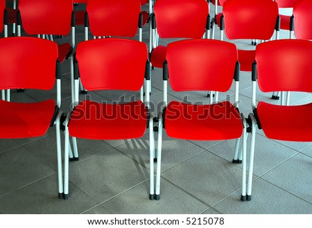 Conference room with red seats, grey floor