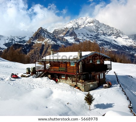 A mountain lodge covered by snow, winter season