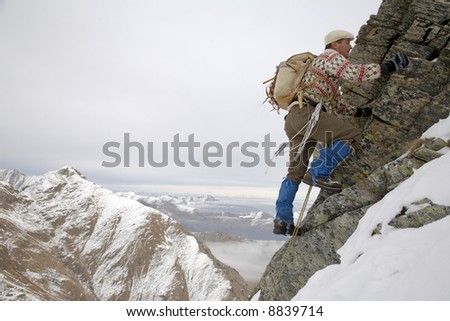 old style rock climber; winter season, horizontal orientation; italian alps