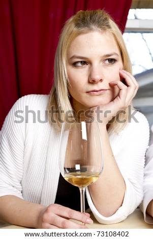 Beautiful young girls having drink in bar holding glasses