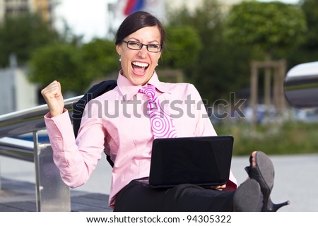 Business woman in the tie suit with notebook computer