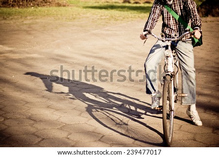 Picture presents men on bike dropping shadow