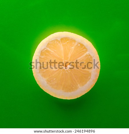 One slice of lemon on red background, square shot