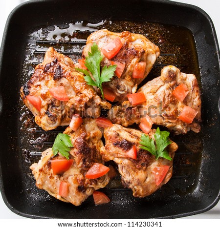 cook chicken piece with spice on frying pan