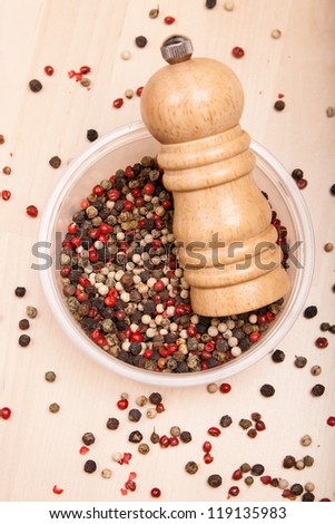different pepper corn in bowl with pepper mill