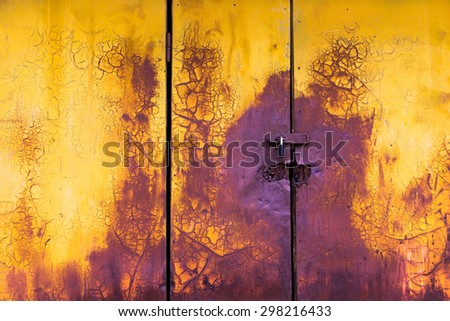 old paint horizontal door background yellow and purple colors with crack and scratch