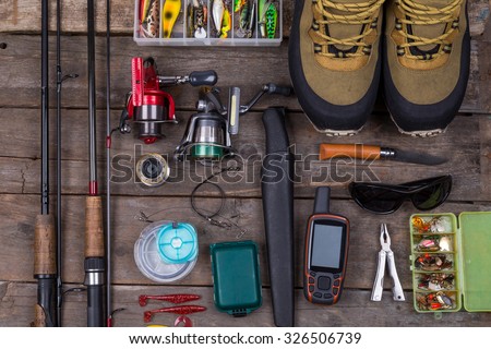 fishing tackles and fishing gear on tinber boards look on top