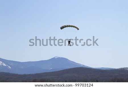 NOVONEZHINO, RUSSIA - MARCH 31, 2012: Airshow devoted to 14 anniversary of the Primorsky Aeroclub, Novonezhino, Russia, march 31, 2012. The program - skydivers jumping.