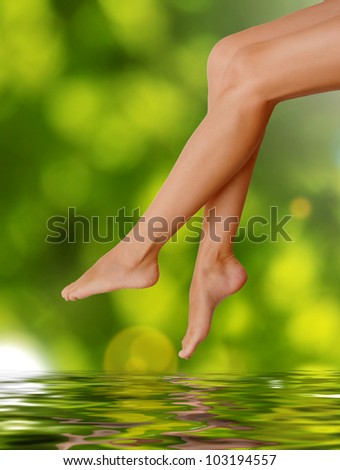 Long woman legs  on green background. Spa concept