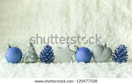 Row of silver and blue decoration elements on the white background