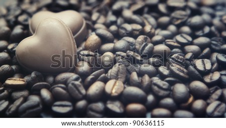 Chocolate hearts on the coffee beans background