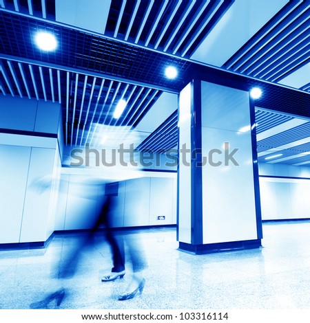 Subway corridor, hurried female white-collar workers.