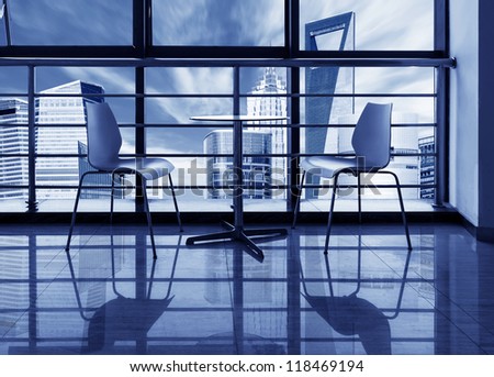 The large windows of the office, out of the window of a skyscraper.