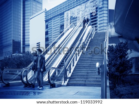 Escalator of Shanghai streets, skyscraper buildings.