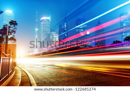 The Light Trails On The Modern Building Background In Shanghai China.