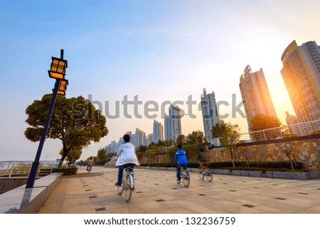 Sunset under the Shanghai teenager riding a bicycle.