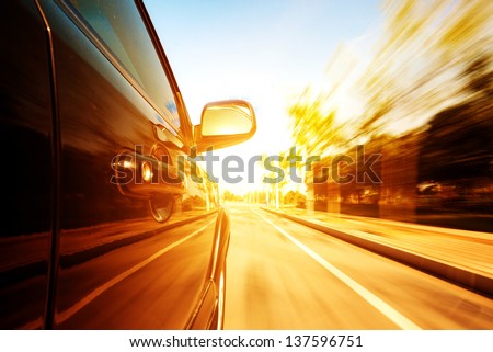 A car driving on a motorway at high speeds, overtaking other cars