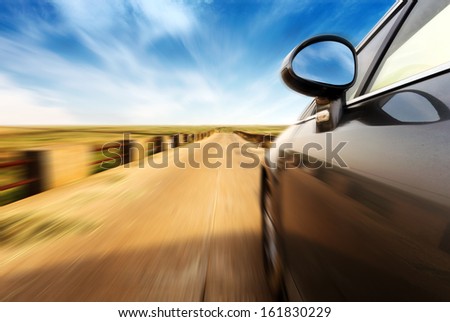 A Car At High Speed On The Road In The Countryside