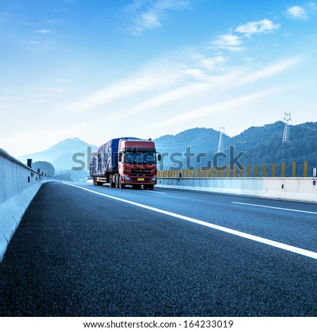 Red Truck On The Highway At High Speeds.