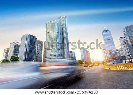 The streets of Hangzhou, China, skyscrapers and fast-Benz cars.
