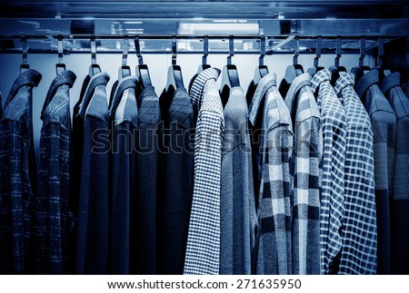 Mens plaid shirts on hangers in a retail store