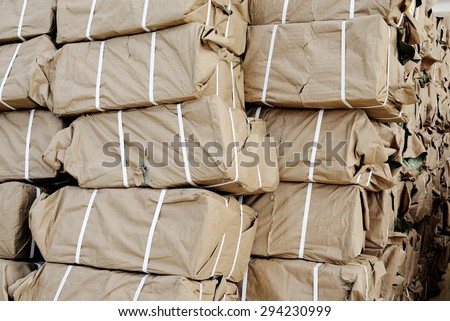 A pile of brown parcel wrapped in brown paper books.