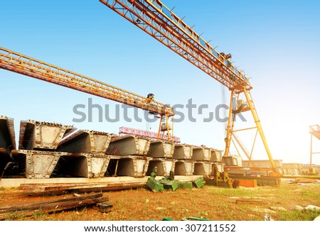 Bridge construction site, bridge cranes and cement slab.