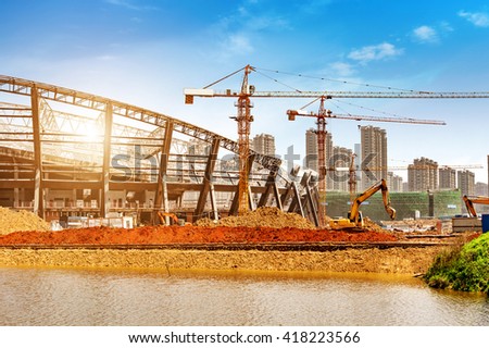 Construction sites, steel structures and cranes under the blue sky.