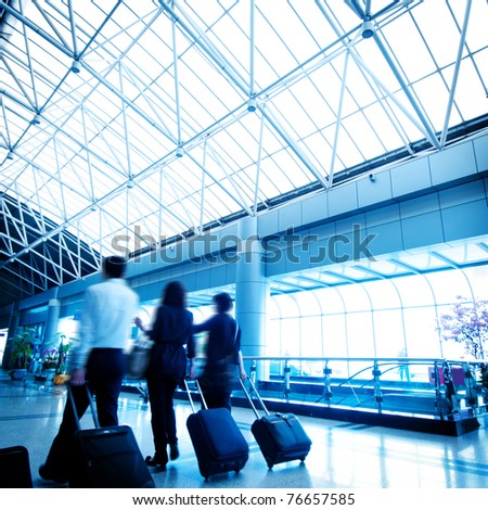 Clean tiled floor, reflection of light on floor and blurred view of people walking