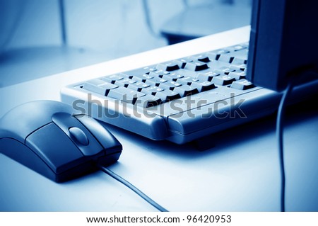Blue hue of the keyboard and mouse, close-up closeup.
