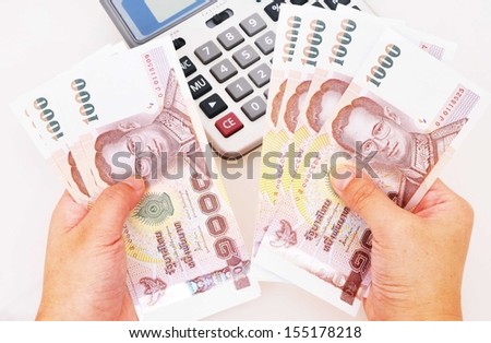calculator and money in hand