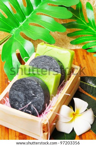 Handmade soap bars on Bamboo mat with Frangipani flowers and leaf.