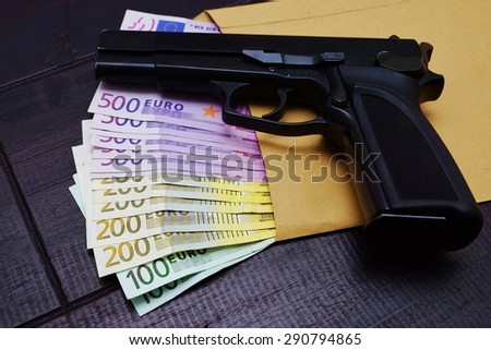 Gun and money on a table