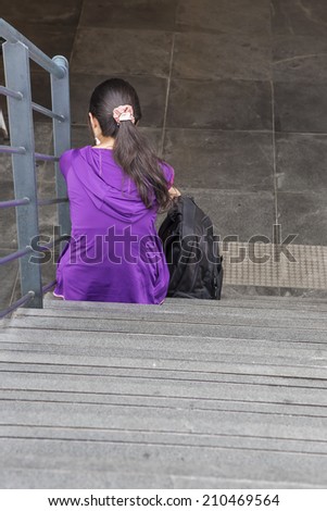 lonely woman sitting on steps
