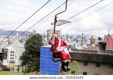 MATSUYAMA,JAPAN - November 29, 2013: The Santa Claus statue sat in the ropeway of single person to the Bitchu Matsuyama Castle