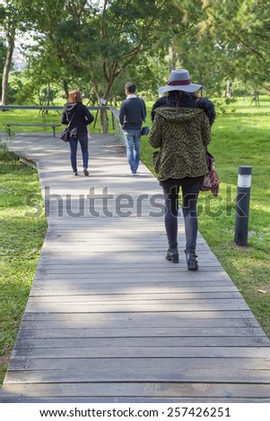 People walking on the wooden road