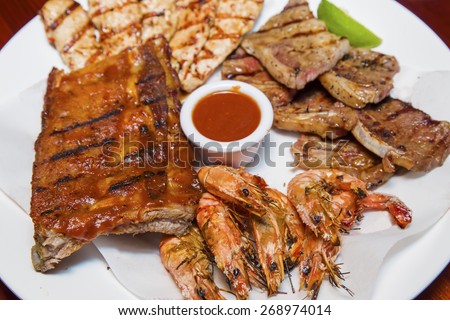 char-grilled short ribs, chicken strips, shrimps and BBQ pork ribs platter