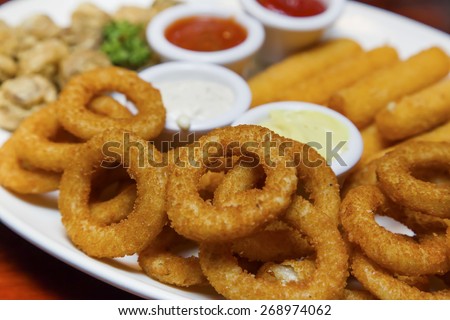 Fried onion rings, fried Mozzarella cheese sticks and fried mushrooms platter