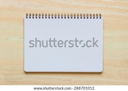 Top view of note book on wooden table
