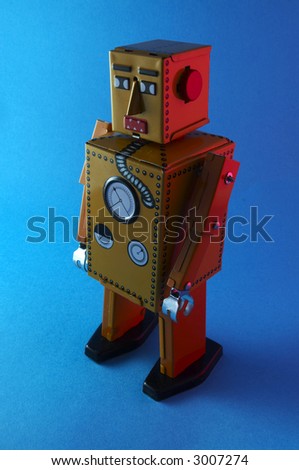 Vintage Robot toy on blue with red back light
