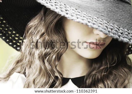 Portrait of beautiful young woman with hat