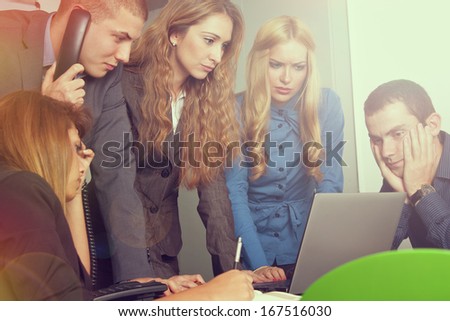 Team of business people anxiously watching computer. Lens flare and light effect