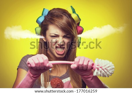 Angry housewife trying to break the brush