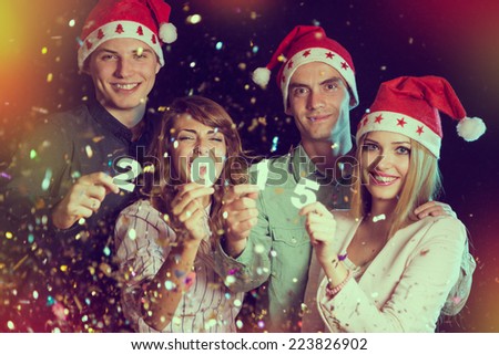 Four young people celebrating New Year, holding card numbers 2, 0, 1 and 5