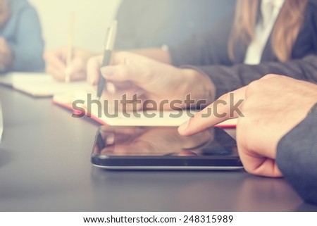Group of young business people taking notes on a meeting