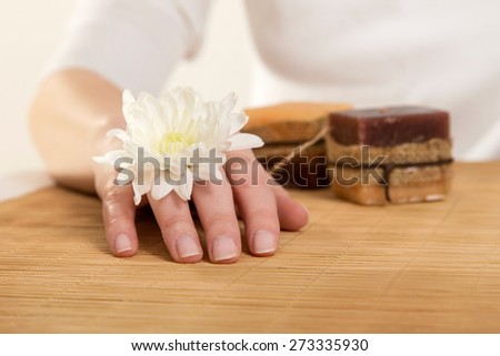 Woman with margarita flower on her hand in a nail salon