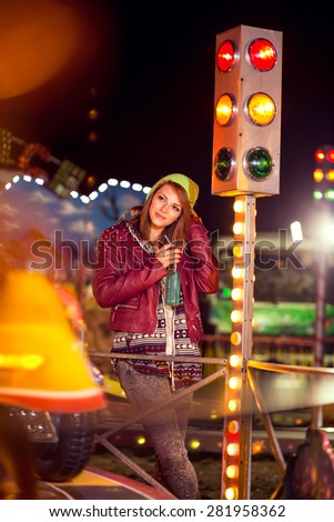 Young girl listening to music at the theme park