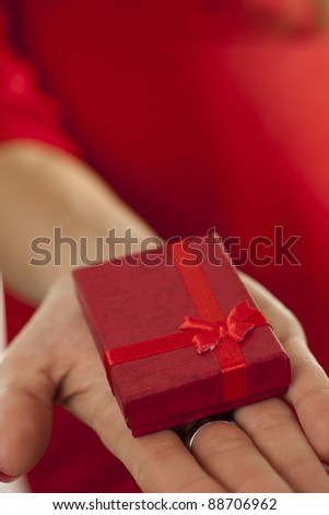 Small red gift in open hand .